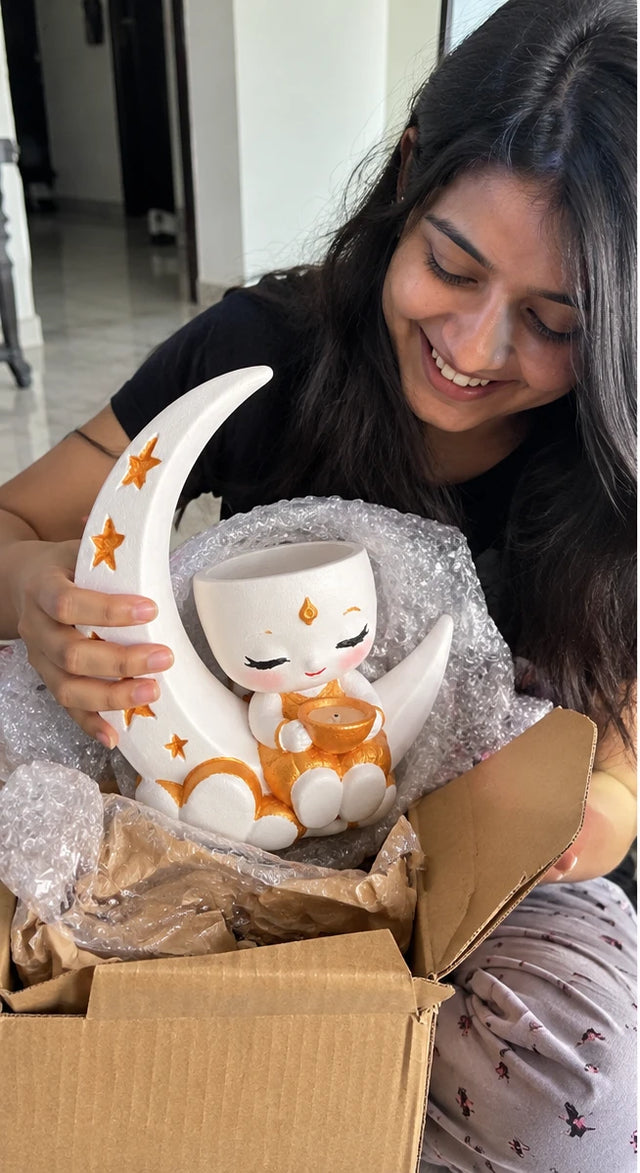 A MiniKin customer lifting a Festival Moon Planter out of its packaging