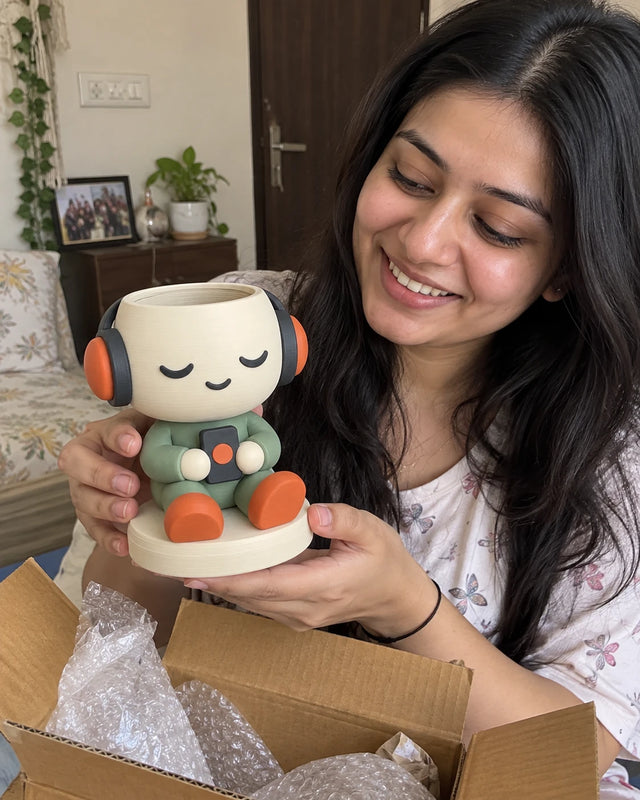 A MiniKin customer unboxing a Headphone Planter at home
